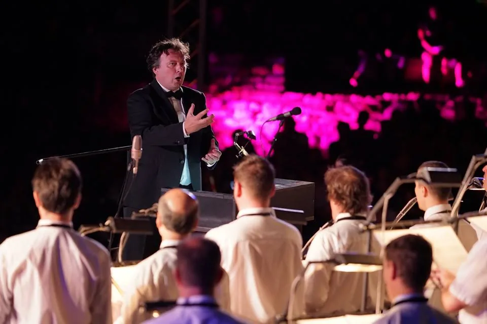 Conductor leading a choir in concert