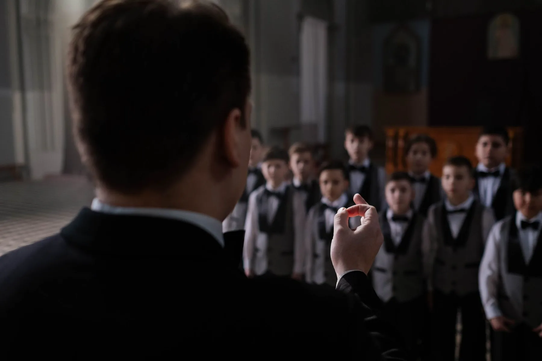Conductor leading a boys' choir Conductor leading a boys' choir